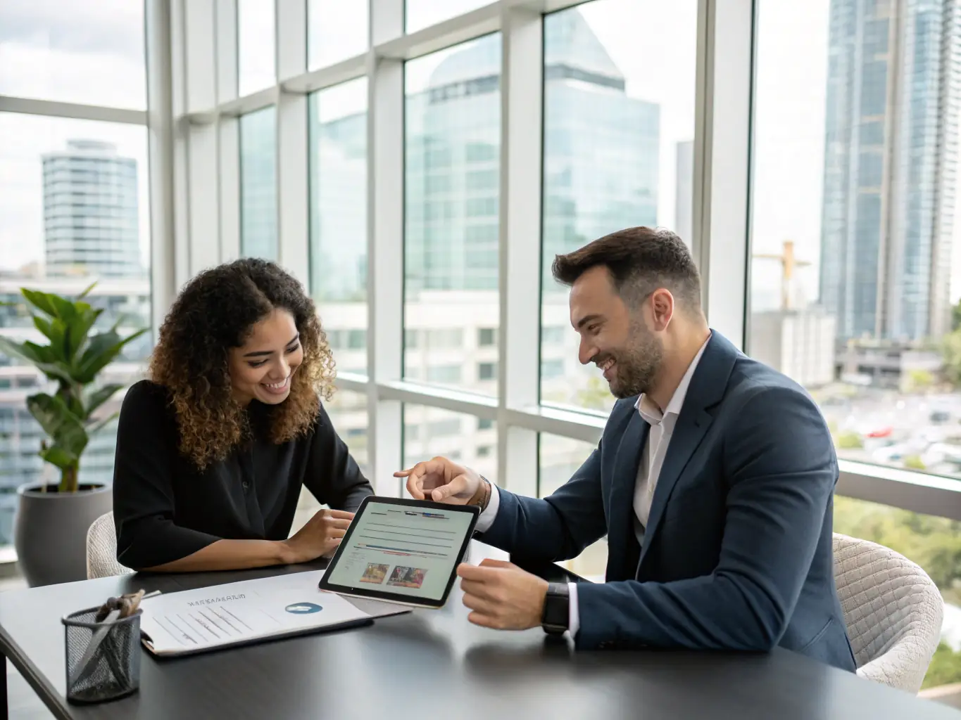 A real estate agent and client reviewing digital transaction documents on a tablet, illustrating streamlined processes for Marip's Transaction Facilitation service.